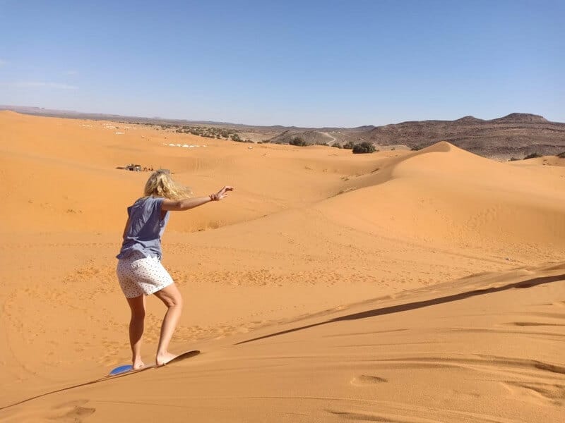 Sandboarding in the dunes in Merzouga in Morocco