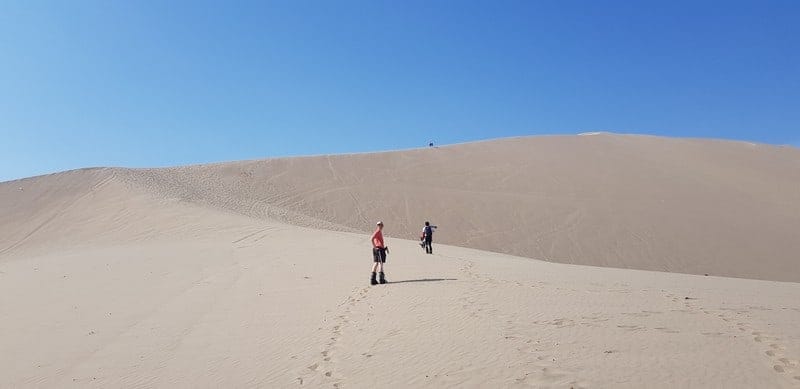 hiking up the dunes in Huacachina Peru